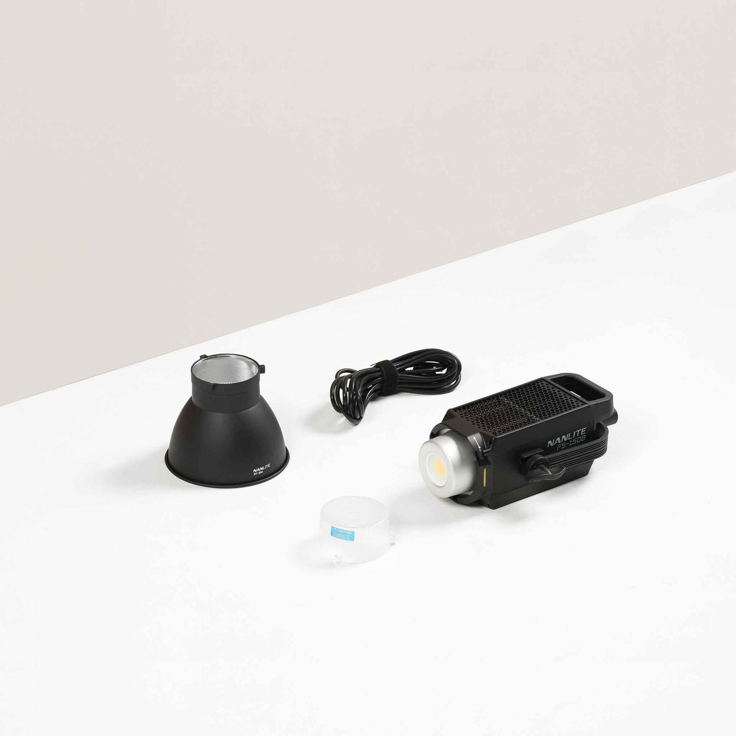 Nanlite FS-150B Bi-Color AC LED Monolight contents with 45 degree reflector, COB protective cap, and power cord