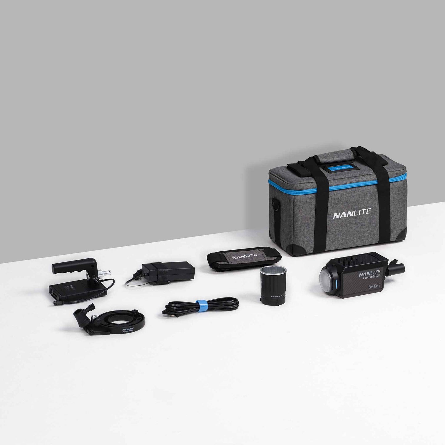 Forza 60CR RGBLAC LED Spotlight contents with NPF battery grip, Bowens adapter, 45 degree mini reflector, COB protective cap, power adapter with v-mount plate, power cable, and padded carrying case