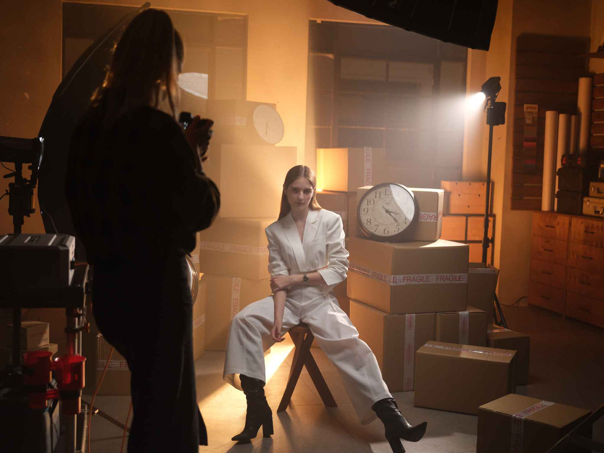 Photographer taking picture of model with Nanlite FC-120B Bi-Color LED Spotlight shining light onto model from behind